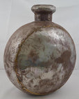 Oval-shaped antique Indian metal water jug with a rustic finish, close-up view.