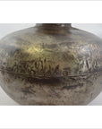 Close-up of a silver metal Indian water jug with round shape, riveted seam, and tarnished textured surface.