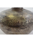 Close-up of a silver metal Indian water jug with round shape, riveted seam, and tarnished textured surface.