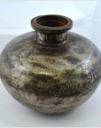 Silver metal antique water jug with round body, narrow neck, and engraved patterns, close-up on white background.