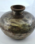 Silver metal antique water jug with round body, narrow neck, and engraved patterns, close-up on white background.