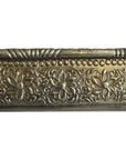 Silver metal Indian repoussé rectangular frame with embossed repeating floral and vine motifs, close-up view.
