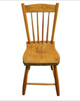 Brown wood Indonesian chair with curved backrest and vertical slats, front view on white background.