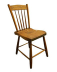 Brown wooden dining chair with slatted backrest and gently worn seat on a white background.