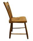 Light wood chair with slatted back, side view, minimalist design, set against a plain white background.