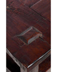 Close-up of a natural stain wood Indonesian coffee table corner with visible grain and raised rectangular joint detail.