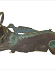 Close-up of hand-carved Indonesian deer wall plaque with blue-green accents and a blue bird on its back.