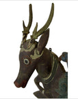 Brown carved wood Indonesian deer wall plaque with real antlers, detailed eyes, and expressive face, close-up view.
