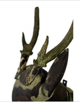 Close-up of brown wooden Indonesian deer wall plaque with two tall hand-carved antlers and large pointed ears.