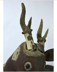Close-up of brown weathered wood deer wall plaque with hand-carved antlers, plain background.