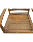 Brown wooden Indonesian Java chair with slatted seat, armrests, diamond cut-out, on white background, top view.