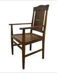 Dark wood armchair with slatted seat and diamond cut-out backrest on white background.