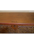 Brown wood chest with ornate carved floral patterns and front center keyhole, shown from the front.