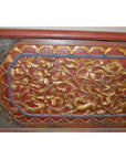 Red wood Madura blanket chest with gold floral carvings and ornate carved borders, front view.