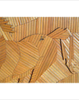 Natural brown wood wall decor with angled slats forming an inlay horse design, displayed as a close-up.