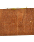 Brown wood wall decor showing the back with a yellow hanging wire attached at the top.