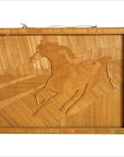 Brown wood wall decor with inlaid galloping horse design and mountain backdrop, close-up view.