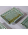 Light green ceramic rectangular dish with floral patterns and brownish discoloration, Japanese Celadon style.