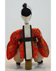 Red and gold kimono Japanese doll with white and black obi, Kyoto-made, Taisho period, rear view.