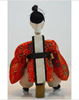 Red and gold kimono Japanese doll with white and black obi, Kyoto-made, Taisho period, rear view.