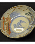 Cream porcelain Imari bowl with scalloped edges, decorated with boats, people, fish, waves, trees and clouds motif.