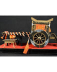 Red and black lacquered Japanese festival carts with ornate details and orange cords displayed on a red platform.