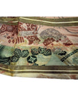 Close-up of muted color Japanese silk sash with floral and abstract patterns.