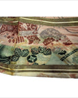 Close-up of muted color Japanese silk sash with floral and abstract patterns.