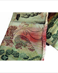 Colorful silk sash close-up with floral and bow patterns, 11.5 inches wide, showing detailed stitching.