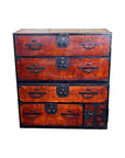 Brown Keyaki wood Isho-Dansu chest with metal handles, metal accents, and multiple drawers, front view.
