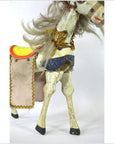 Vintage Japanese two-headed horse toy with yellow and red saddle, blue harness, gray mane, side view.