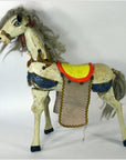 Plastic two-headed horse toy with yellow saddle, gray mane and tail, blue and red accents, shown on plain background.