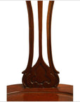 Dark wood Javanese swivel desk chair with carved back and brown lacquer finish against white background.