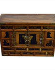 Dark wood antique Korean chest with ornate front panels, butterfly brass hardware, 19th-century design, close-up view.