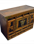 Dark wood chest with brass butterfly hardware, ornate front hinges, and multiple drawers, 19th century.