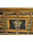 Brown wood chest close-up with brass butterfly hardware on drawers and doors, antique Korean, 19th century.
