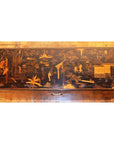 Black lacquer rectangular trunk with gold Asian landscape design on lid, displayed on a wooden floor.
