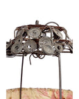 Close-up of a wire frame lantern with spiral design, draped in pink and beige fabric.