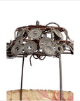 Close-up of a wire frame lantern with spiral design, draped in pink and beige fabric.