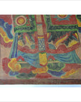 Multicolored Laotian parchment painting with ornate clouds, red, green, yellow, and blue accents, close-up view.