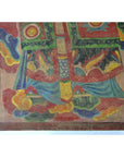 Multicolored Laotian parchment painting with ornate clouds, red, green, yellow, and blue accents, close-up view.
