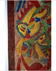 Yellow Laotian parchment painting with two dragons, blue and red details on a vibrant background, close-up view.