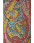 Bold red, yellow, and green Asian dragon painted on Laotian parchment with swirling clouds, close-up view.