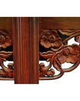 Close-up of antique elm wood altar table with stained finish and detailed carved floral designs.