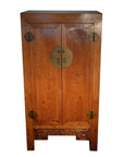 Brown wooden antique Chinese armoire with double doors, brass handles, and carved base panel.