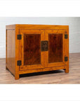 Two-toned patina burl and elm wood cabinet with doors, metal hinges, and brass lock.