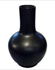 Tall black celadon vase with a matte finish, modern design, displayed alone against a neutral background.
