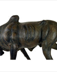 Brown leather gnu sculpture with visible ribs in a hunched walking pose, handmade, shown in good condition.