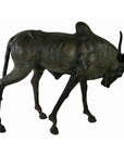 Brown leather gnu sculpture with thin body, curved horns, and lowered head, handmade, close-up view.