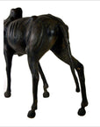 Brown leather gnu sculpture showing back legs, ribcage, and torso on a white background.